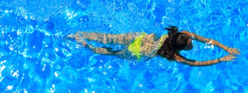 A woman with swims in a swimming pool