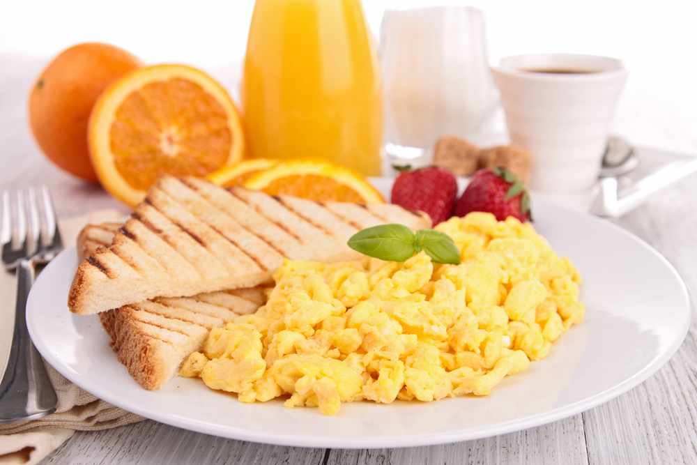 Breakfast with scrambled eggs, orange juice and coffee